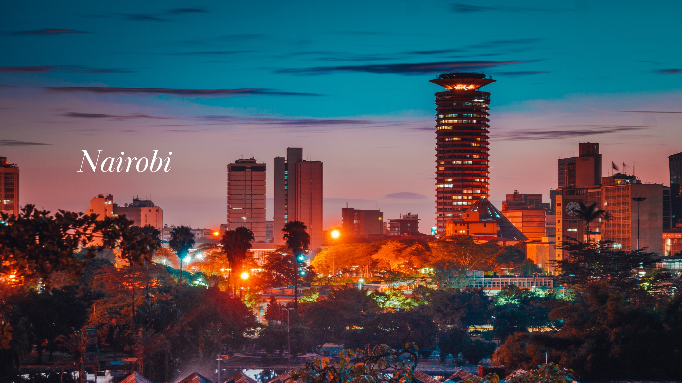 Nairobi city skyline at dusk, with illuminated buildings and city streets beneath a colourful evening sky.